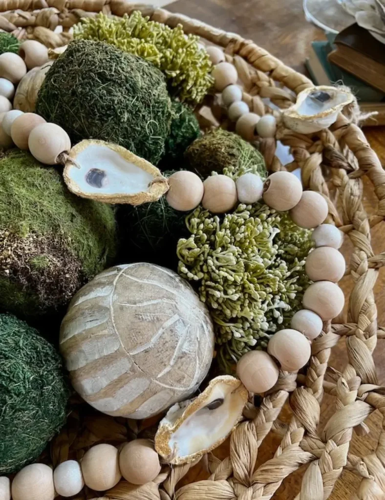 Oyster shell and wood bead garland with gold-leafed shell rims and jute tassels