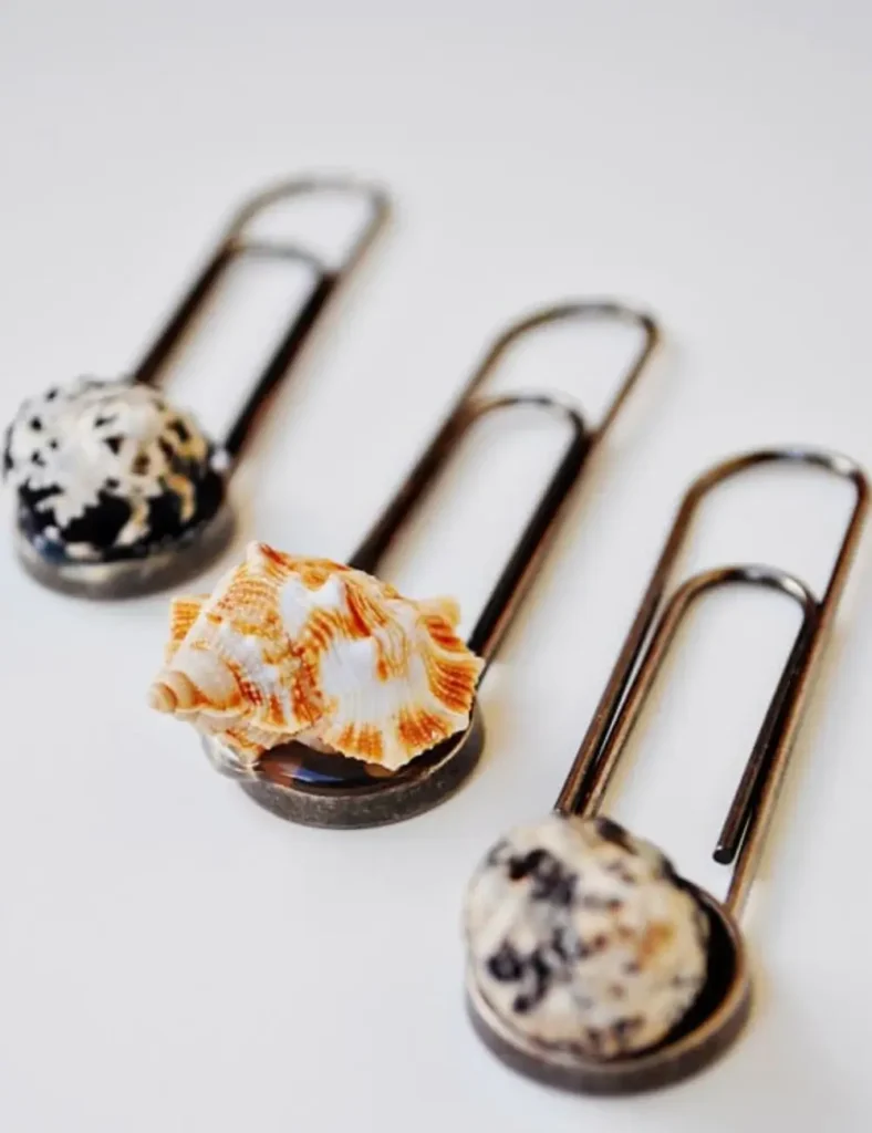 Paper clips topped with small glued-on seashells