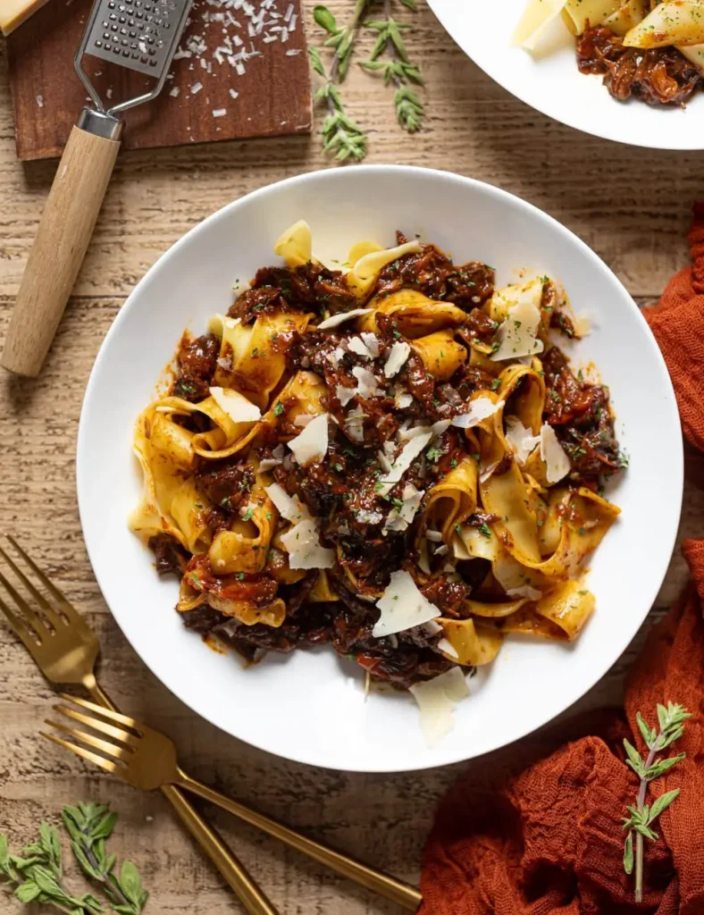 Pappardelle pasta topped with shredded braised steak ragu and grated Parmesan