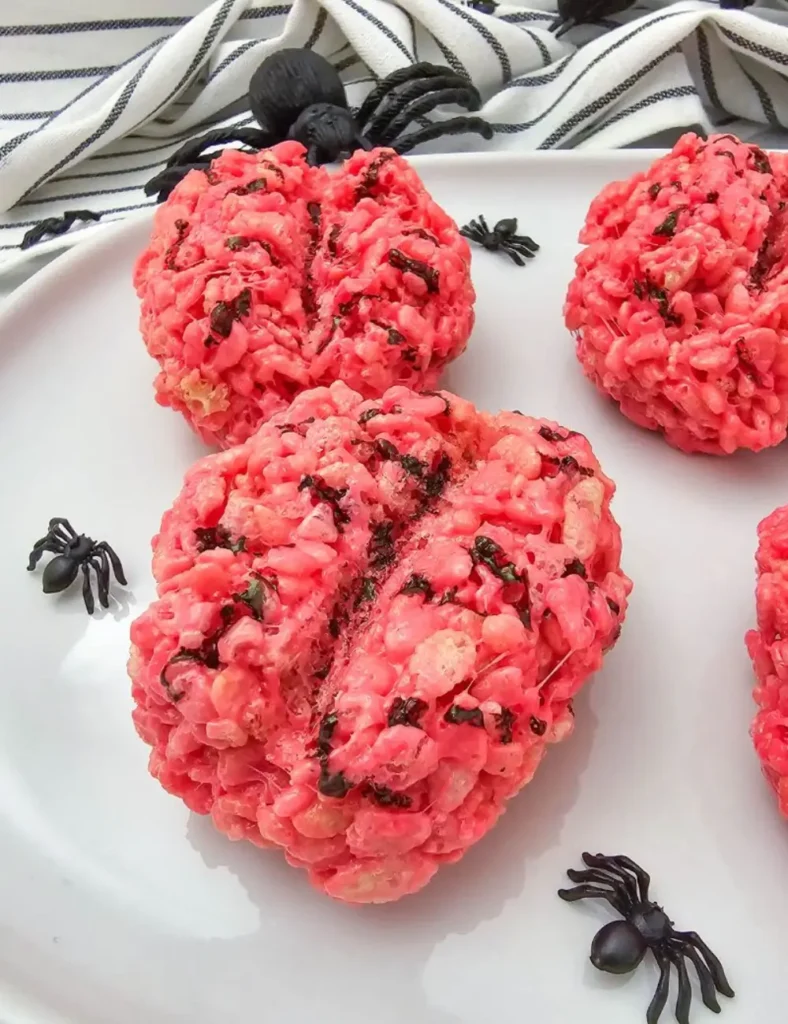 Pink Rice Krispie treats shaped like brains with painted red vein details