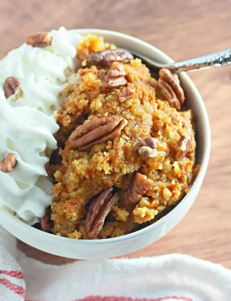 Pumpkin cobbler made in a slow cooker topped with a golden cake crumble