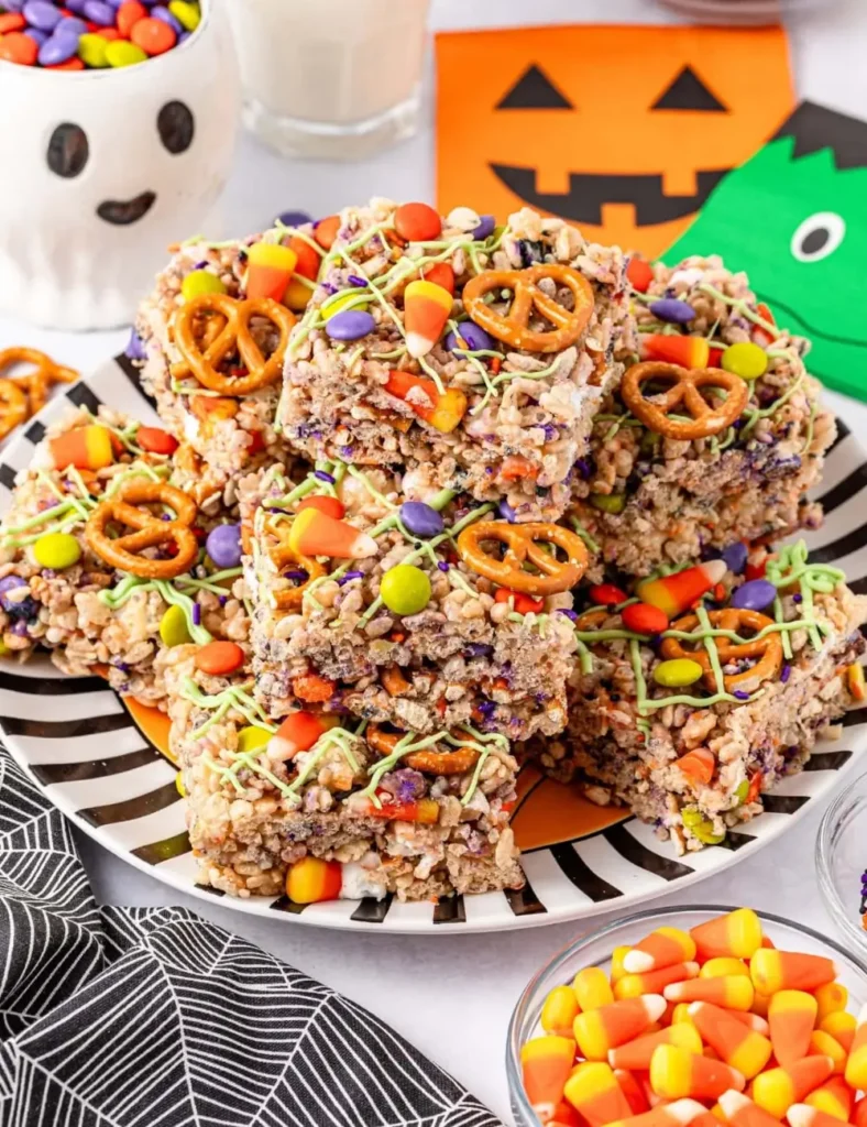 Rice Krispie treats topped with Halloween M&Ms, candy corn, and pretzels