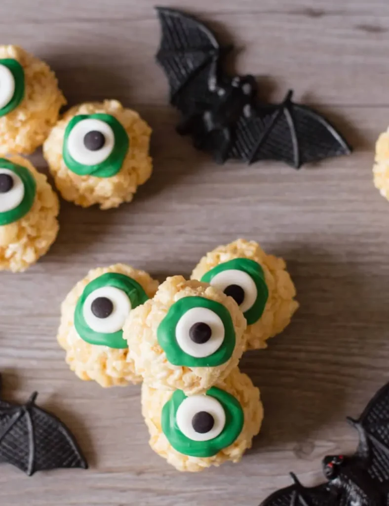 Round Rice Krispie treats decorated with fondant and green candy to look like eyeballs