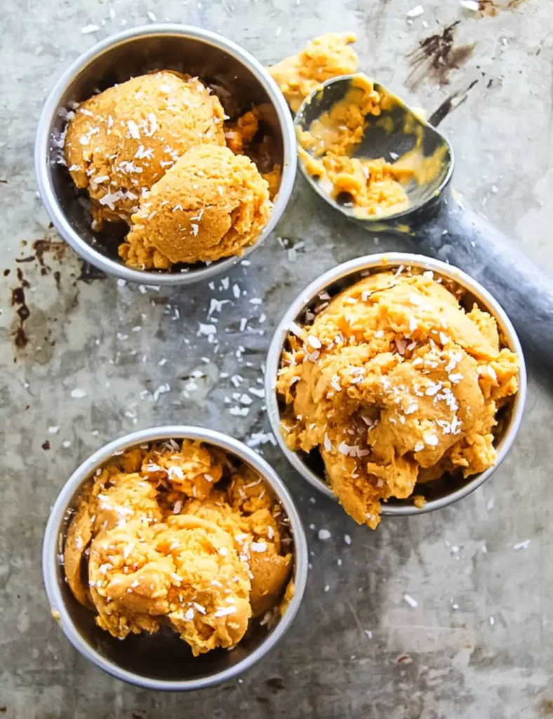 Scoops of no-churn coconut pumpkin ice cream in a baking dish
