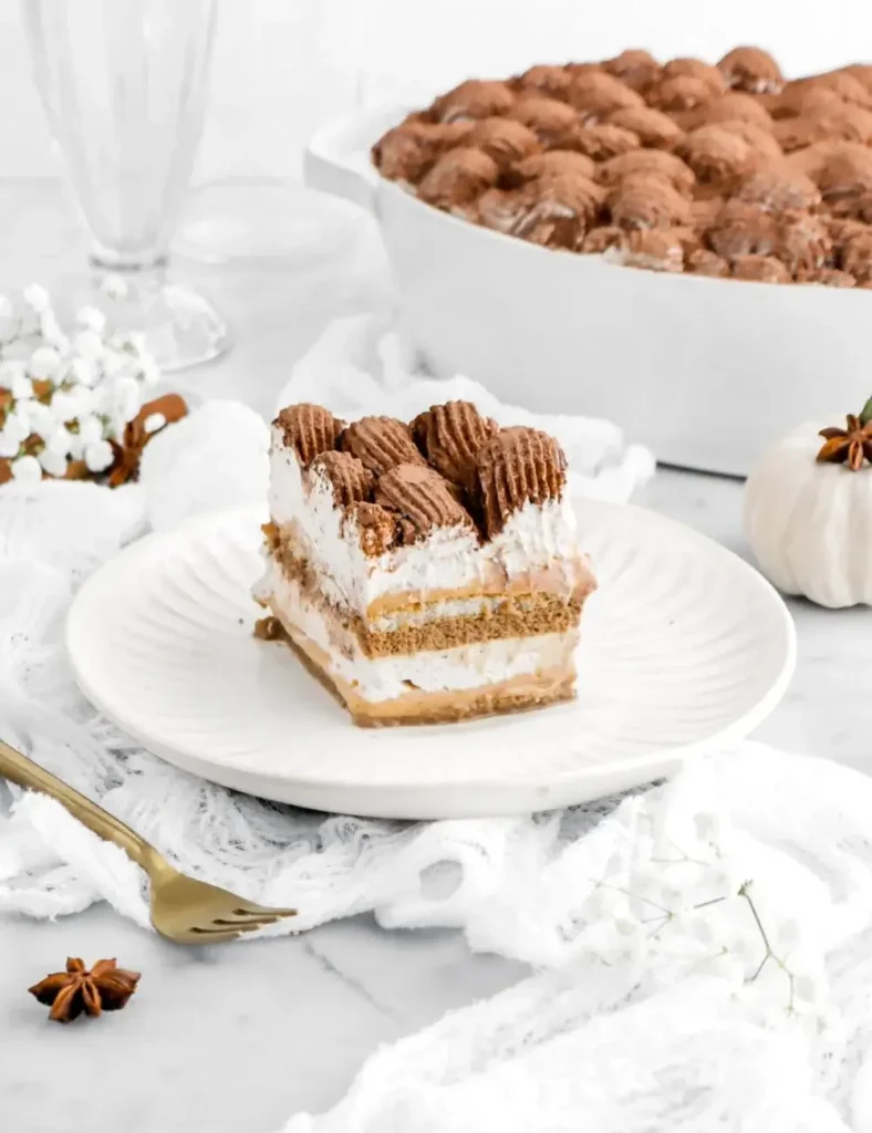 Slice of spiced pumpkin tiramisu topped with cocoa powder