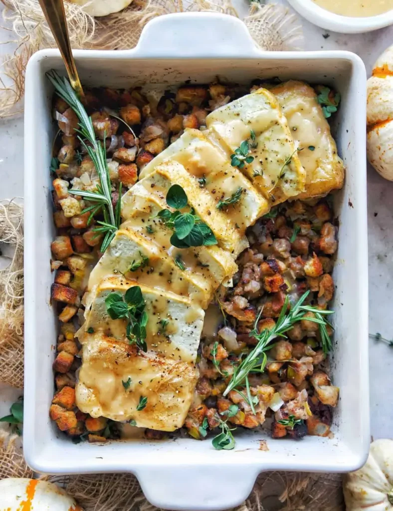 Sliced baked tofu with crisp rice paper skin served over pecan leek stuffing with gravy poured over