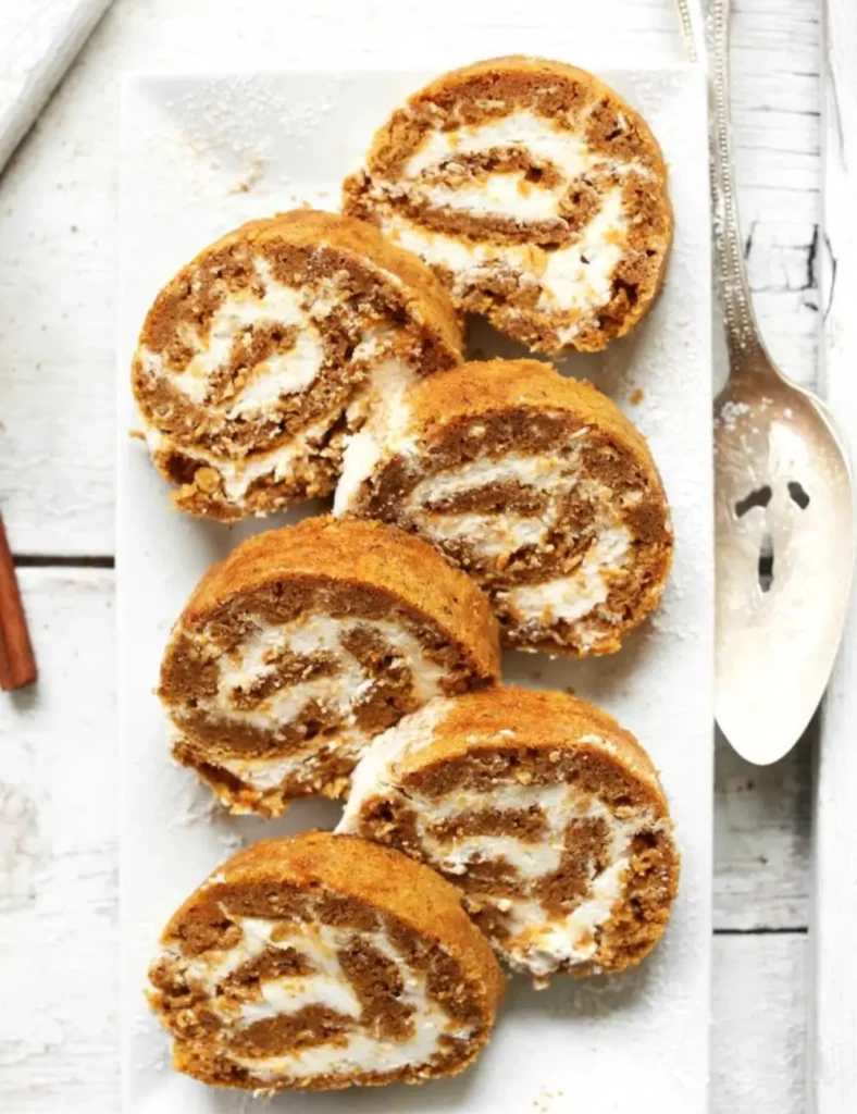 Sliced vegan gluten-free pumpkin roll showing the spiral of cream cheese filling