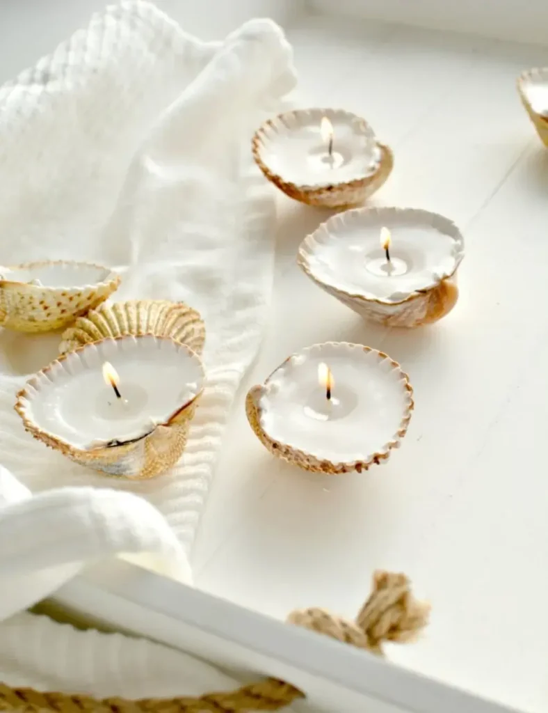 Small seashells filled with wax and lit wicks, used as tealight candles
