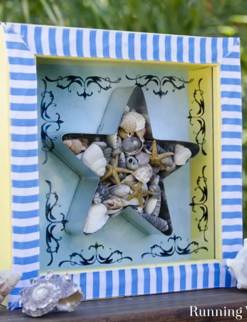 Star-shaped shadowbox filled with tiny seashells and starfish