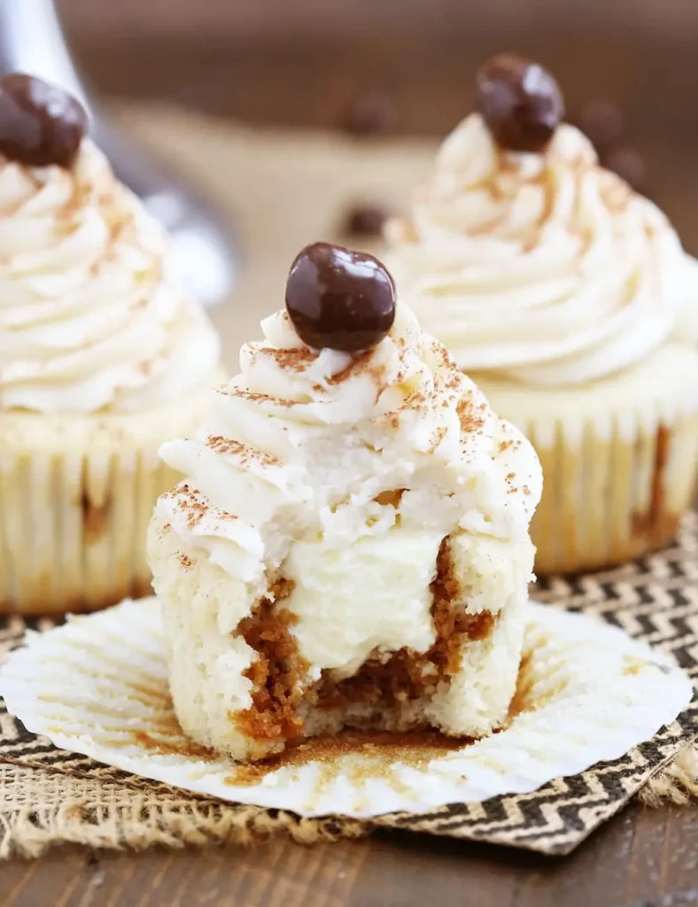 Tiramisu cupcakes topped with mascarpone frosting and dusted with cocoa powder