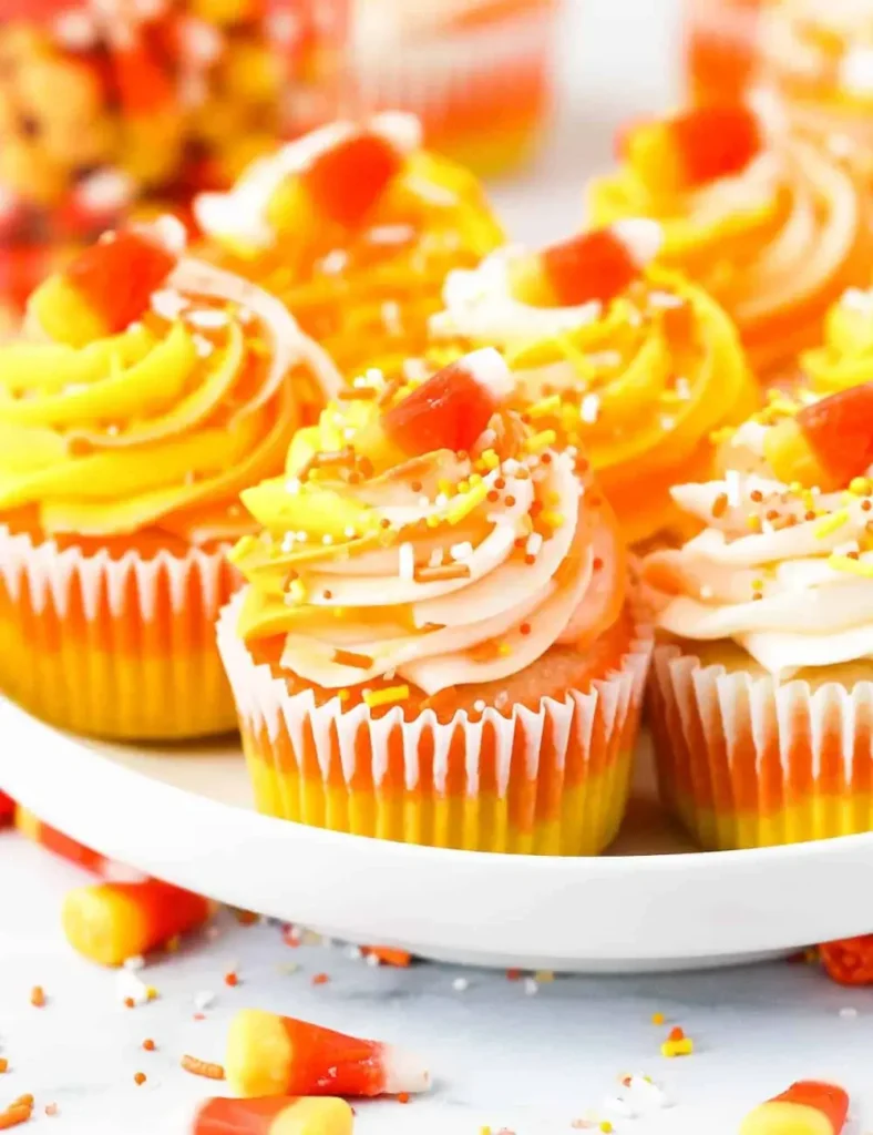 Vanilla cupcake decorated with yellow, orange and white buttercream to look like candy corn