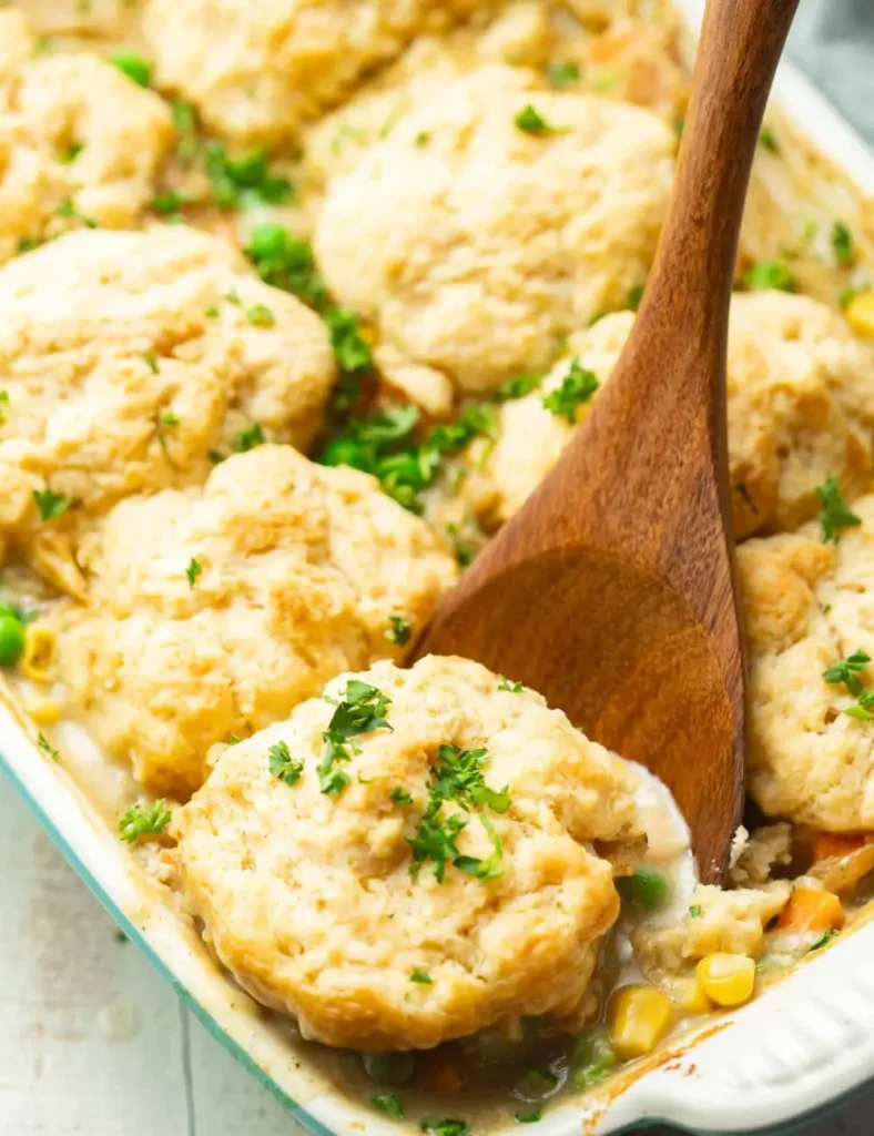 Vegan chicken and biscuits casserole in a baking dish with golden drop biscuits on top