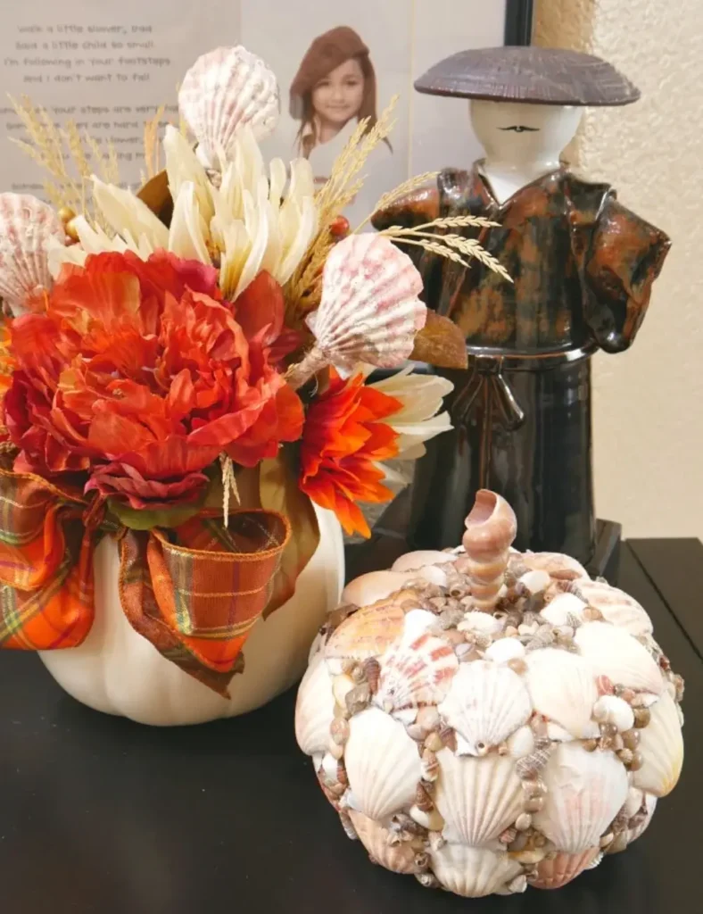 White painted foam pumpkin covered in seashells for coastal fall decor
