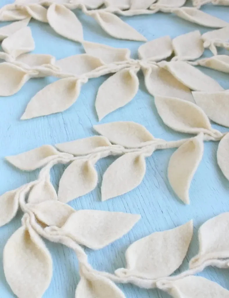 Wool felt leaf garland draped around a window frame