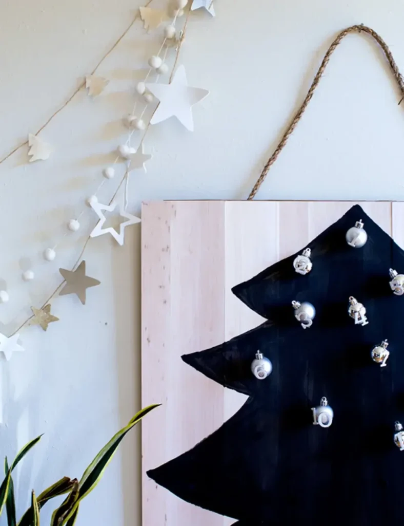 Balsa wood Christmas tree advent calendar with numbered silver ornaments attached by Velcro