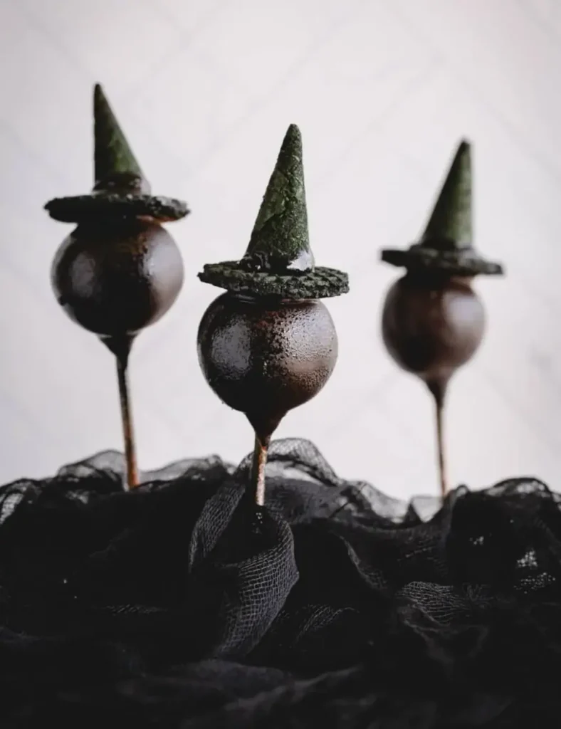 Chocolate Halloween cake pops topped with black witch hats made from mini waffle cones