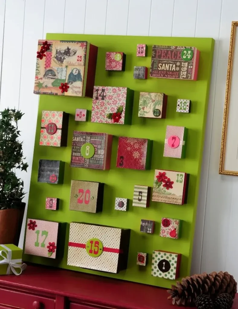 Colorful decoupaged paper mache boxes of varying sizes glued onto a large canvas advent calendar
