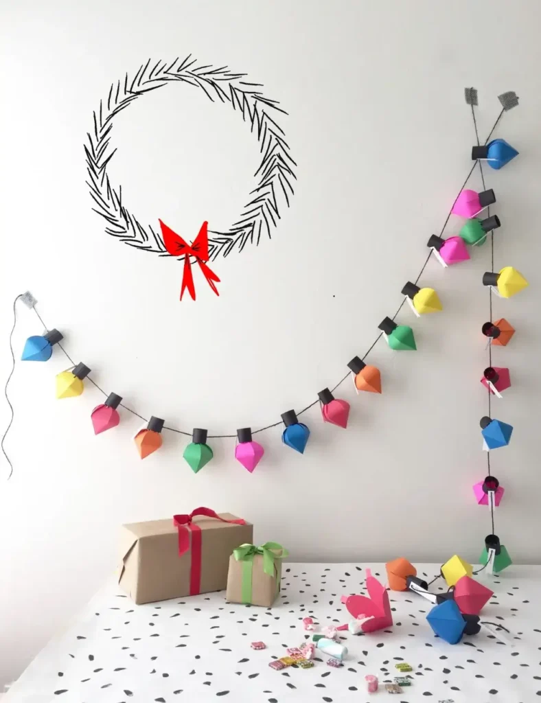 Colorful paper light bulb shapes strung together as a hanging Christmas advent calendar garland