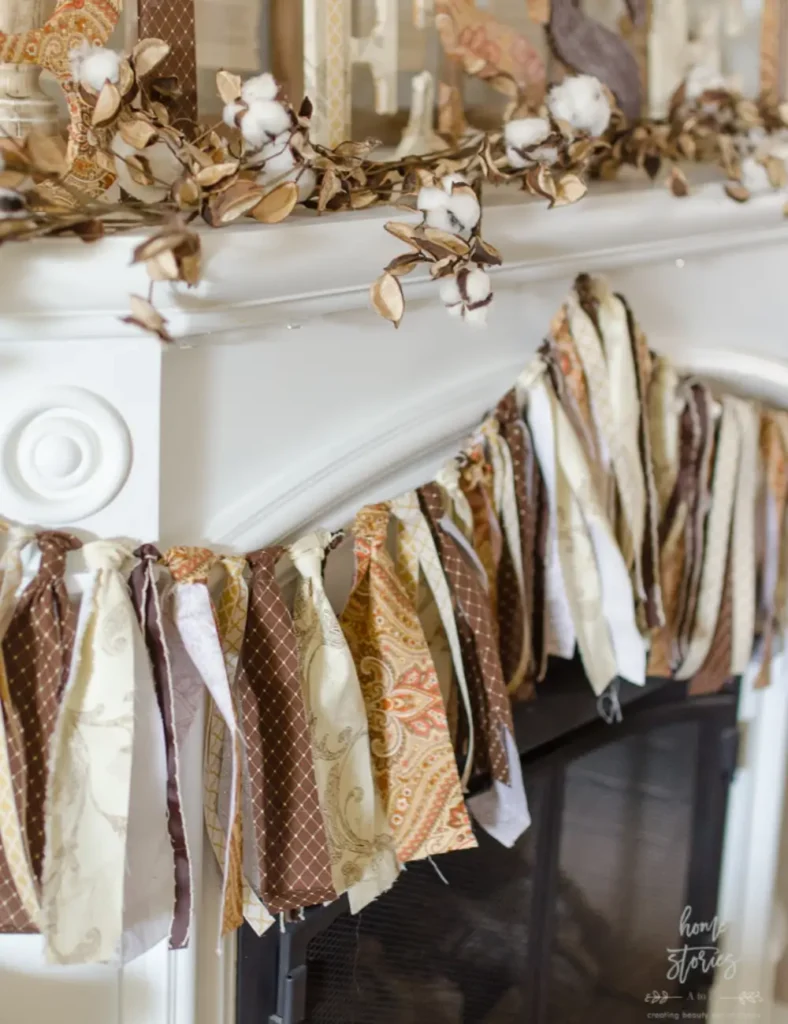 Fall garland made from knotted strips of patterned fabric and ribbon tied along a length of twine